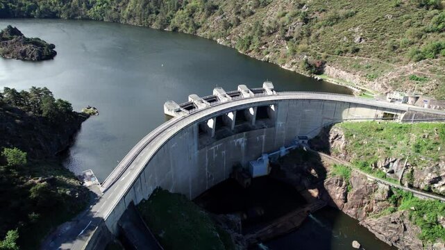 aerial shot going backward revealing hte Grangent Dam and the landscape around on a sunny day near Saint Etienne city in Loire departement, Auvergne Rhone Alpes region, France