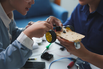 Students building a robot car in robotics class