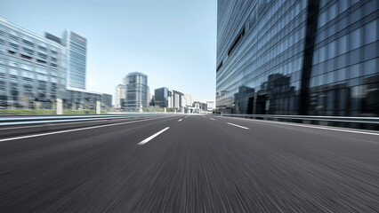 Obraz premium Deep perspective asphalt road in the city glass curtain wall building