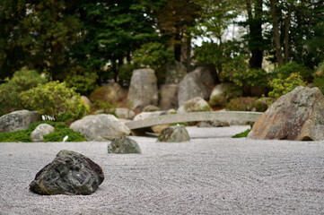Japanese zen rock garden with bridge and stones