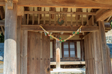 Korean culture with Gum-Jul (straw rope for preventing evil) hanging on the gate after a child is...