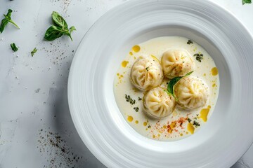 boiled pelmeni with cream, white plate, top view, 