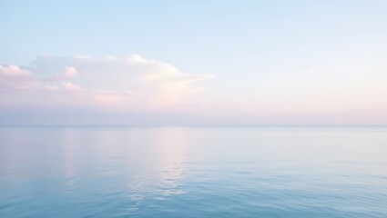 Obraz premium minimalist seascape photo of a peaceful ocean at daybreak sky is filled with soft pink to light blue pastel clouds clouds are reflected