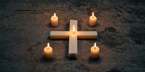 A serene arrangement of a wooden cross surrounded by lit candles, creating a peaceful and spiritual atmosphere on a textured surface.