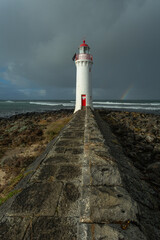Port Fairy Lighthouse and path with storm clouds in the background