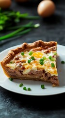 Pieces of homemade pie with eggs, green onions and canned tuna on a white plate
