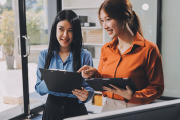 Entrepreneurs and business people conference in modern meeting room, happy multiracial coworkers have fun cooperating working together at office meeting, asian teamwork concept