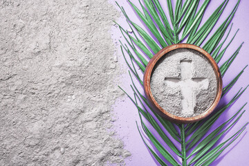 Bowl with ashes and cross print on purple background. Ash Wednesday