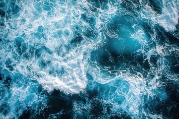 Fototapeta premium Overhead shot shows turbulent sea water with foaming waves