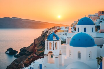 Stunning sunset over Oia village, Santorini, Greece, with white and blue domed churches