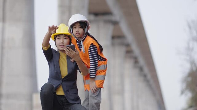 Teachers and students studying at a construction site.