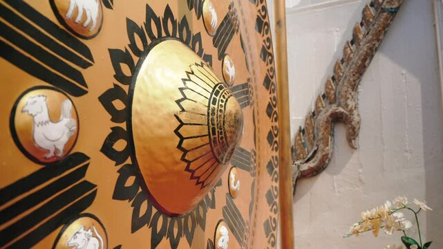 Hanging mallet strikes huge golden gong in Wat Saket temple 