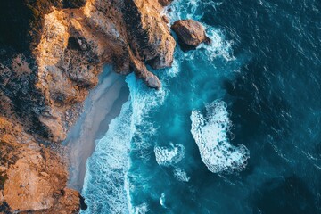 Obraz premium Experience the beauty of a coastal landscape with golden cliffs and turquoise waves, inviting you to explore the serene shore and vibrant ocean.
