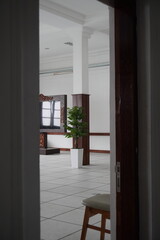 Pillars in an empty meeting room with meeting equipment and atrificial plants inside with a vintage concept