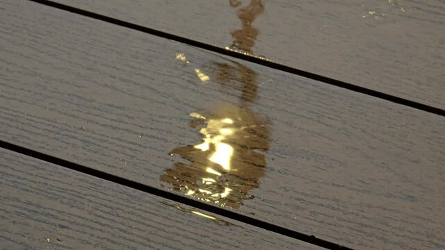 rainwater falls on the surface of the wooden floor