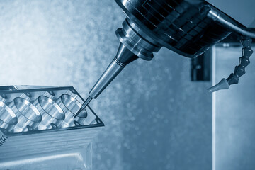 The 5-axis machining center cutting the cylinder block with solid ball nose end mill tool in the...