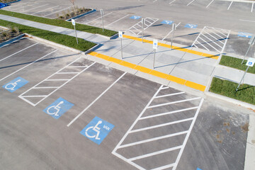 A parking lot with handicap parking spaces and a crosswalk