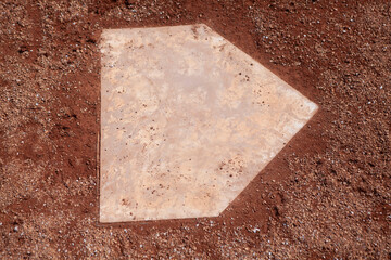 baseball base home plate in red dirt infield
