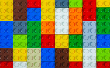 A stack of colorful toy blocks seen from above, forming one large square shape. Makes an interesting background and pattern. Toys and games. Leisure and recreation