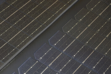 Close up of solarcell texture showing grid patterns and reflective surfaces during daylight