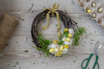 DIY process of woman making candid Easter wreath arrangement decor. Small business, self employed...