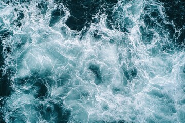 Fototapeta premium Turbulent ocean water creates swirling patterns of white and teal