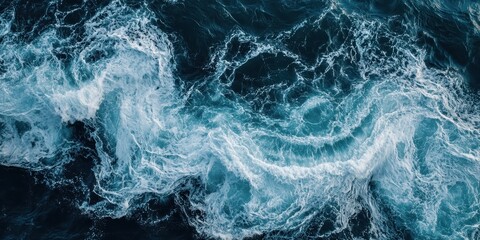 Obraz premium Turbulent ocean waves create foamy patterns on the water surface