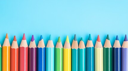 Diverse Colorful Pencils Arranged Horizontally on a Light Blue Background for Creative Projects