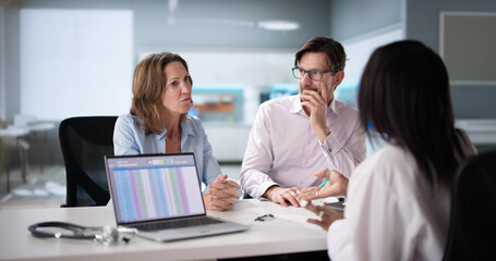 Happy African pregnant couple patient at doctor, talking about ultrasound