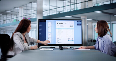 Woman calculating tax invoice on computer