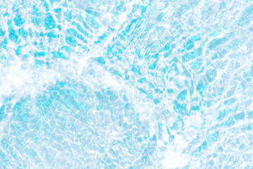 Blue water with ripples on the surface. Defocus blurred transparent blue colored clear calm water surface texture with splashes and bubbles. Water waves with shining pattern texture background.