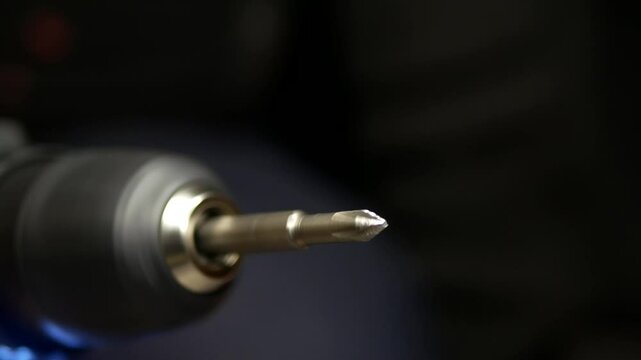 Close-up of cordless screwdriver. Screwdriver attachment rotates at speed. Repair, construction, electrical equipment and modern tools theme