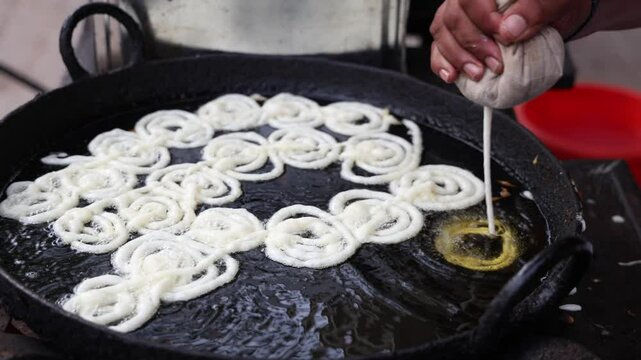 traditional indian jalebi frying at local sweet stall