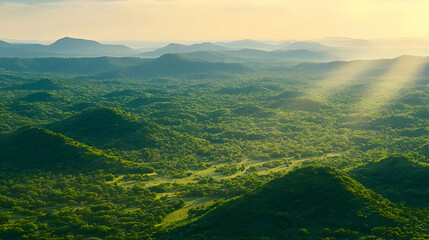 Fototapeta premium Sunrise over lush green hills, aerial view, misty mountains background, ideal for travel brochures