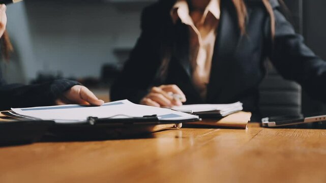 Hands closeup on contact, legal settlement or financial report while reading and making notes. Lawyer team doing work and analyzing documents. Lawyers looking through client finance data together