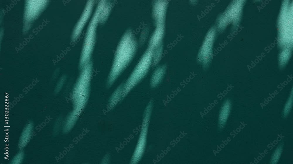 Poster Shadows and Light Create Abstract Patterns on Teal Wall Surface