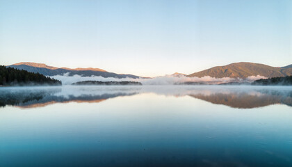 Serene lake reflections in cold morning light, peaceful landscape