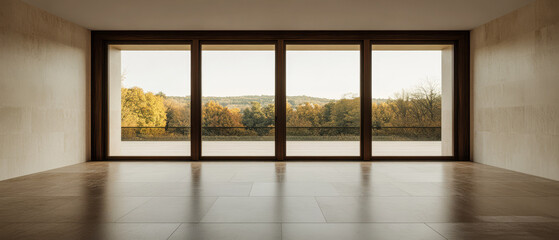 Fototapeta premium Modern interior with large windows showcasing autumn landscape in golden light