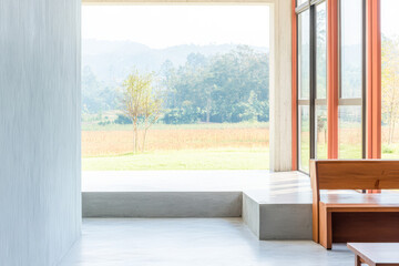 Modern interior design with natural light showcasing a serene landscape view in the background