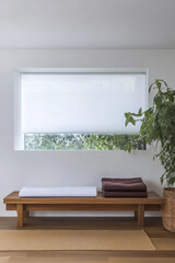 Modern interior design featuring a bench window and greenery in a minimalistic space