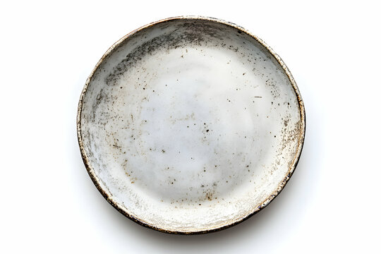 Elevated view of a weathered vintage ceramic plate with speckled surface and rustic brown rim providing visual interest and textural appeal on an isolated white backdrop