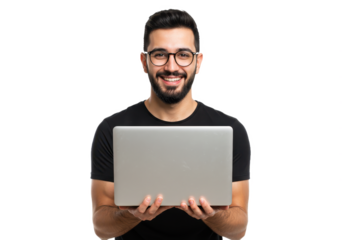 A young man holding a silver laptop in both hands and smiling directly at the camera