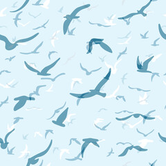 Fototapeta premium Flock of flying silhouette birds. Birds seamless pattern. White seagulls on a blue background. Vector