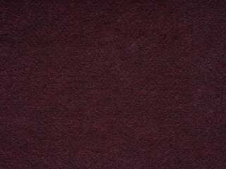 Fototapeta premium A rich burgundy felt texture that conveys a deep and luxurious touch, suggesting sophistication and warmth
