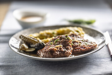 Inverted Beef Schnitzel with Mashed Potatoes and Pickled Cucumbers. Traditional Czech and Slovak Food