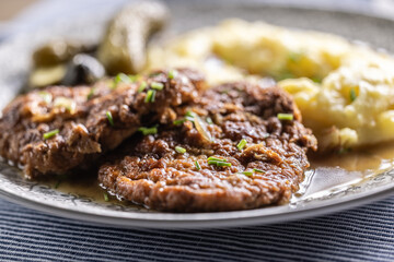 Inverted Beef Schnitzel with Mashed Potatoes and Pickled Cucumbers. Traditional Czech and Slovak Food