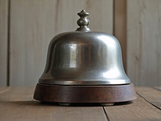 Vintage Silver Bell Resting on a Wooden Base