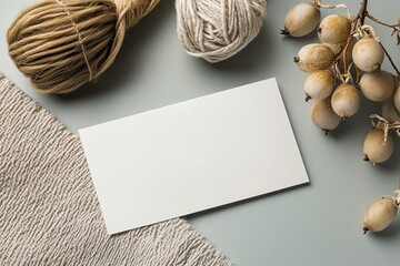 An overhead composition featuring blank paper and natural decorative elements