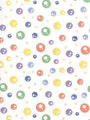 Pastel colored polka dots and circles pattern on white background.
