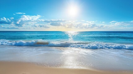 Fototapeta premium A serene beach landscape with gentle waves and a bright sun illuminating the clear blue ocean on a peaceful day.
